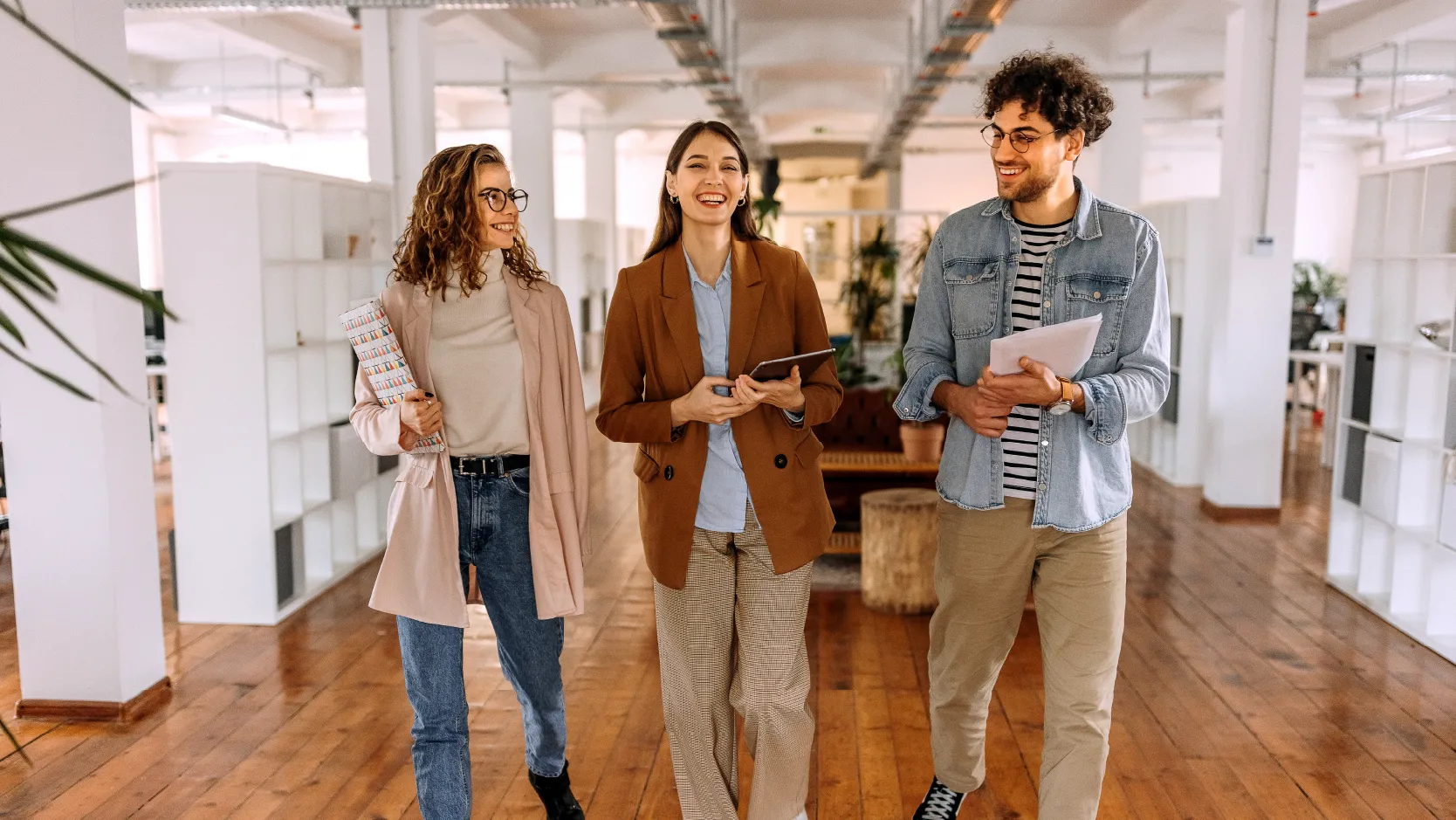 image of young employees in an office walking and discussing insurance leadership opportunities