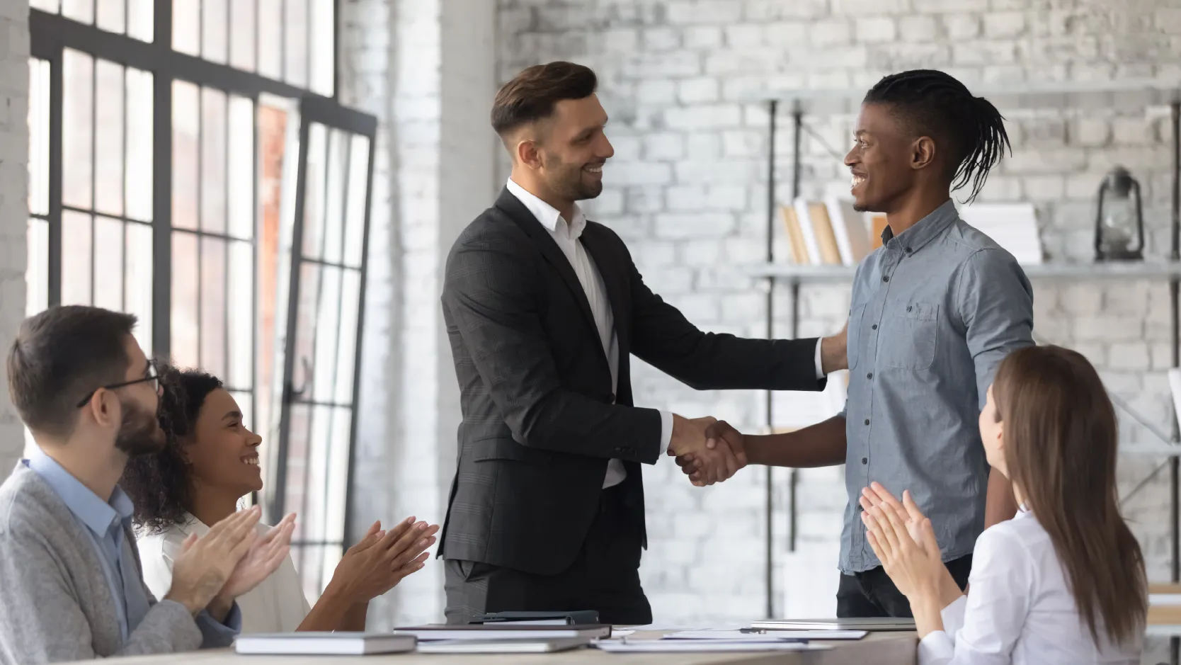 image of a manager congratulating an employee in an office showing the power of recognition