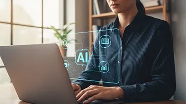 Woman in office typing on a laptop