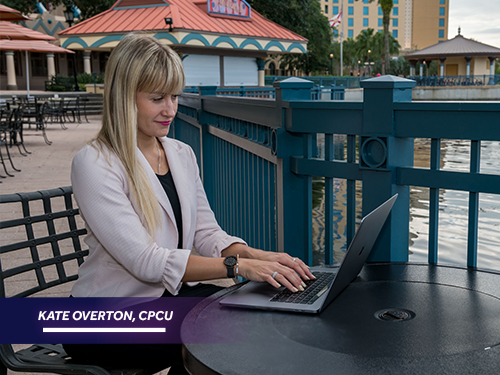 An image of a woman at a laptop illustrating strong customer service as a CPCU designee
