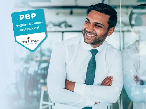 A happy man in business attire smiling and glancing to the right where the PBP badge sits