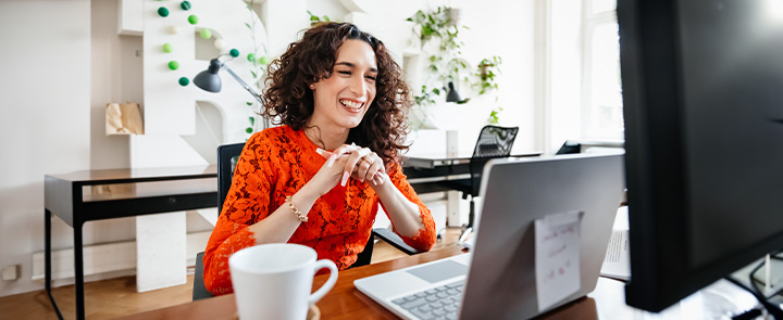 woman smiling at computer