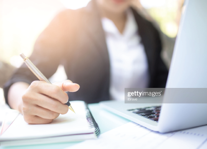 Person writing in notebook