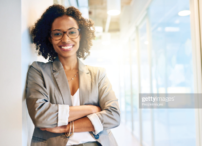 Person with arms folded smiling