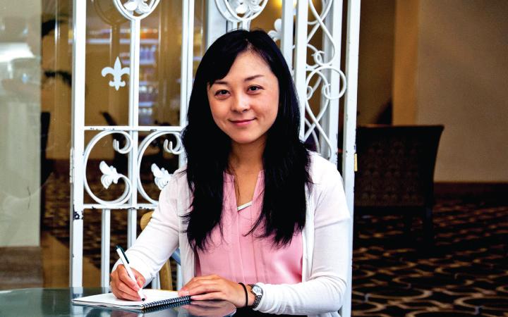 Woman sitting at table with a notebook