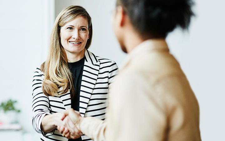 Two women shaking hands