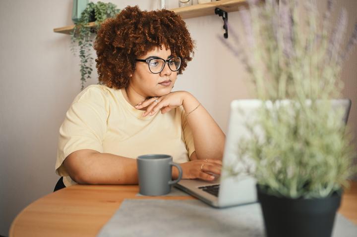 a young woman works on a laptop