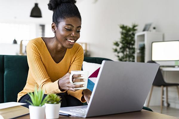 a young black woman studies CE on her laptop