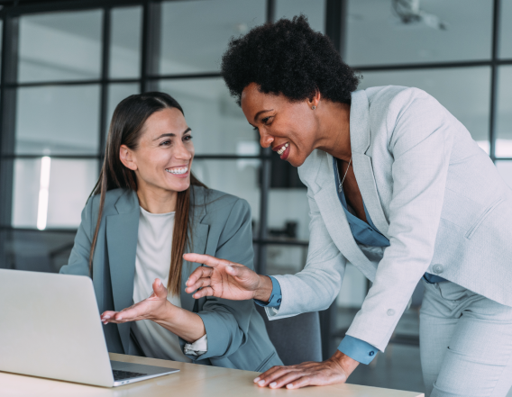 Women talking at computer