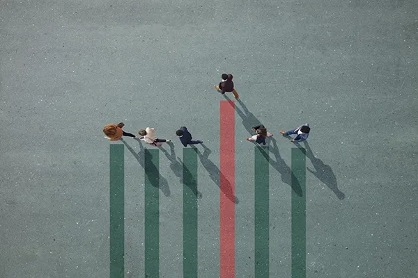 A group of professionals viewed from overhead at staggered intervals with bar graph panels behind them