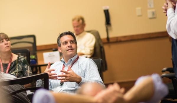 group of people listening and talking during a seminar