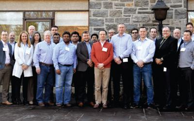Group of people in front of stone wall