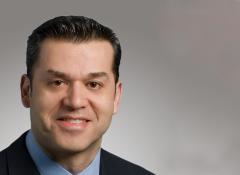 close up headshot of man smiling
