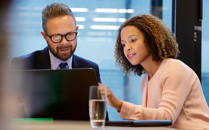 Woman and man looking at computer