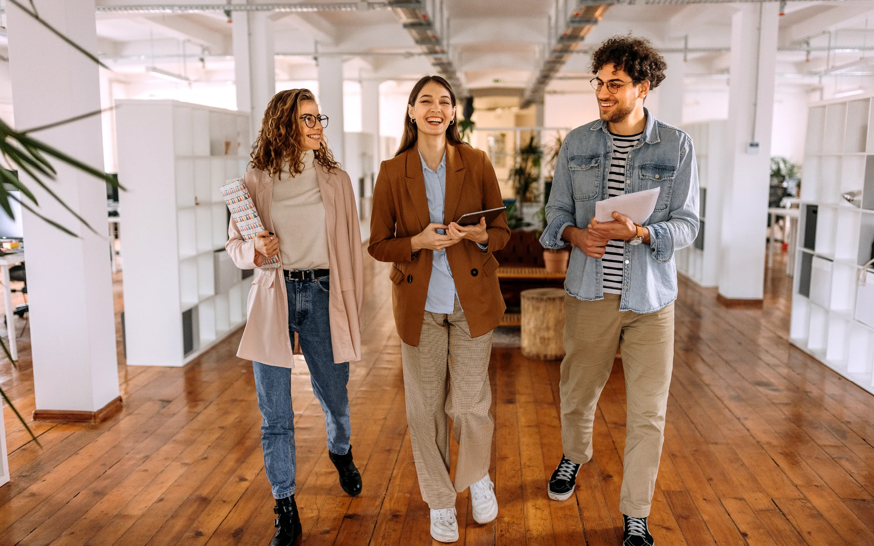 image of young employees in an office walking and discussing insurance leadership opportunities